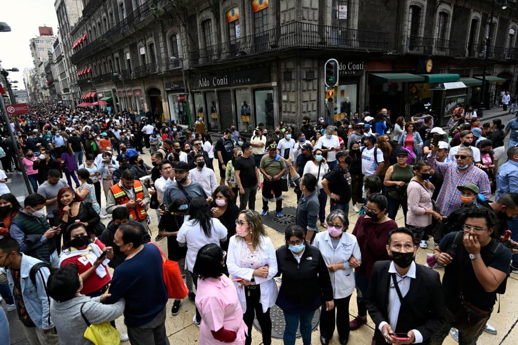 People are seen in the street after an earthquake in Mexico City on September 19, 2022. - A 6.8-magnitude earthquake struck western Mexico on Monday, shaking buildings in Mexico City on the anniversary of two major tremors in 1985 and 2017, seismologists said. (Photo by Alfredo ESTRELLA / AFP) (Photo by ALFREDO ESTRELLA/AFP via Getty Images)