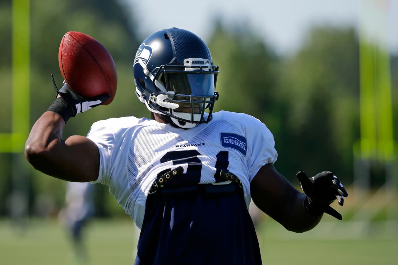 Seattle Seahawks strong safety Kam Chancellor passes the football while playing catch at the start of NFL football training camp, Tuesday, Aug. 1, 2017, in Renton, Wash. (AP Photo/Ted S. Warren)