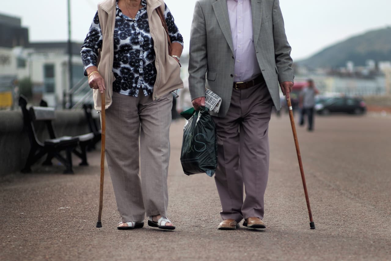 LLANDUDNO, WALES - SEPTEMBER 08: Senior citizens walk along Llandudno Promenade on September 8, 2014 in Llandudno, Wales. Britain is facing multiple problems stemming from an increase in the elderly proportion of its population, including increasing health care costs, strains on its social security system, a shortage of senior care workers and challenges to the employment market. (Photo by Christopher Furlong/Getty Images)