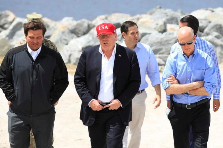 President Donald Trump walks with, from left, Florida Governor Ron DeSantis, Senator Marco Rubio, (R-Fla), and Senator Rick Scott, (R-Fla), during a visit to Lake Okeechobee, Florida, Friday, March 29, 2019.