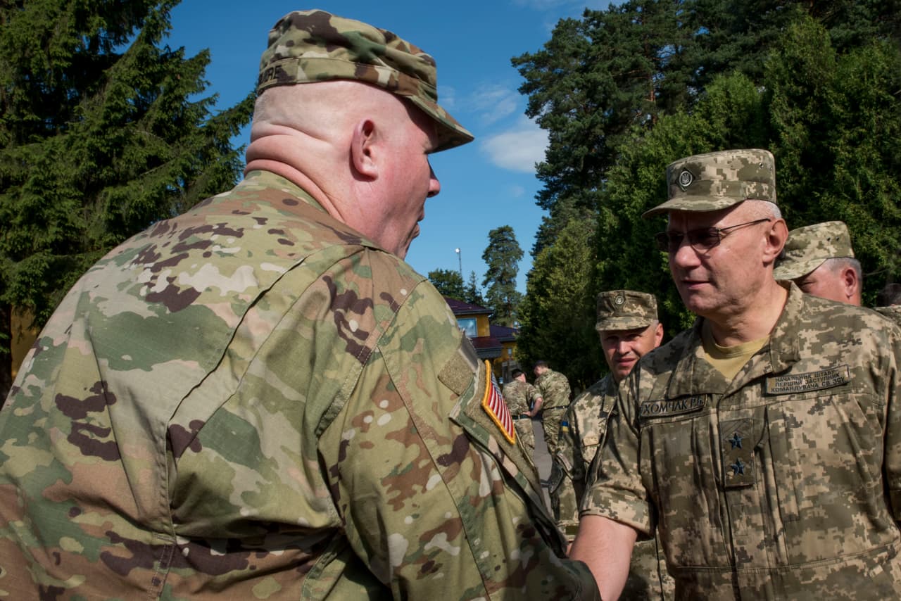 The Deputy Commander of U.S. Army Europe Maj. Gen. Timothy McGuire shakes hands with Ukrainian Army Land Forces Commander Lt. Gen. Ruslan Khomchak at the Rapid Trident 16 distinguished visitor day July 6, 2016. The exercise is a regional command post and field training exercise that involves about 2,000 Soldiers from 13 different nations, being held at the International Peacekeeping and Security Center in Yavoriv, Ukraine June 27 - July 8, 2016. (U.S. Army photo by Sgt. 1st Class Whitney Hughes/Released)