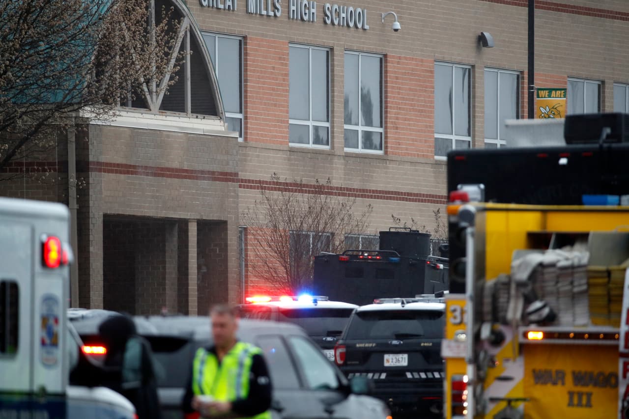 Deputies and federal agents converge on Great Mills High School, the scene of a shooting, Tuesday morning, March 20, 2018 in Great Mills, Md. The shooting left at least three people injured including the shooter. (AP Photo/Alex Brandon )