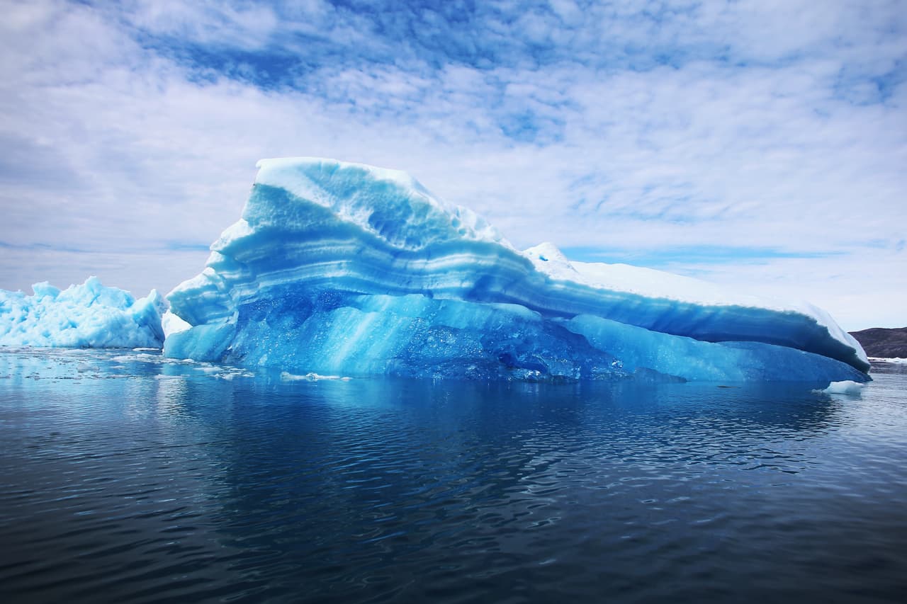 QAQORTOQ, GREENLAND - JULY 30: Calved icebergs from the nearby Twin Glaciers are seen floating on the water on July 30, 2013 in Qaqortoq, Greenland. Boats are a crucial mode of transportation in the country that has few roads. As cities like Miami, New York and other vulnerable spots around the world strategize about how to respond to climate change, many Greenlanders simply do what theyve always done: adapt. "Were used to change, said Greenlander Pilu Neilsen. "We learn to adapt to whatever comes. If all the glaciers melt, well just get more land. (Photo by Joe Raedle/Getty Images)