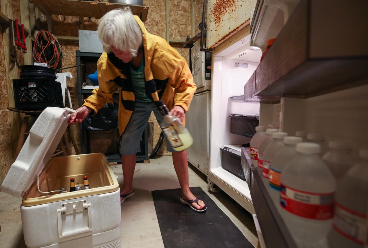 Carolyn Price vacía una nevera en el nivel inferior de su propiedad en Matagorda, Texas, antes de que el huracán Harvey toque tierra. Esta población se prevé será muy afectada por el huracán.
