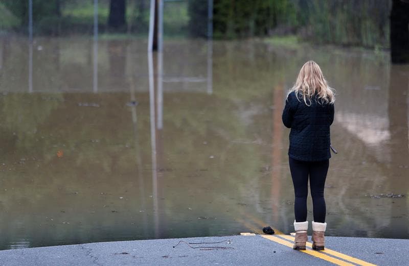 Una mujer observa la carretera inundada en Guerneville. Aunque las lluvias ocasionaron daños materiales, han contribuido notablemente a reducir la sequía que sufre California desde hace 6 años.