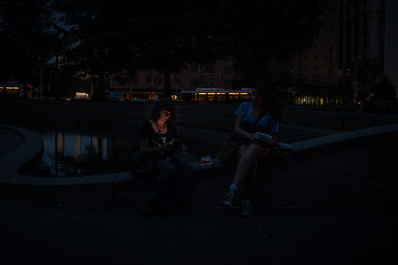NUEVA YORK, NY - 13 DE JULIO: Una mujer intenta hacer una llamada telefónica celular en Columbus Circle durante el apagón. (Foto de David Dee Delgado/Getty Images)