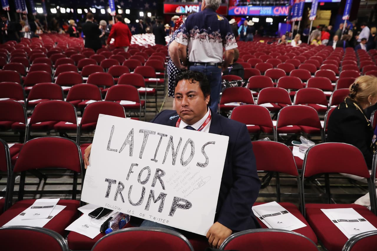 CLEVELAND, OH - JULY 21: A delegate holds a sign that reads "Latino's For Trump" prior to the start of the fourth day of the Republican National Convention on July 21, 2016 at the Quicken Loans Arena in Cleveland, Ohio. Republican presidential candidate Donald Trump received the number of votes needed to secure the party's nomination. An estimated 50,000 people are expected in Cleveland, including hundreds of protesters and members of the media. The four-day Republican National Convention kicked off on July 18. (Photo by Chip Somodevilla/Getty Images)