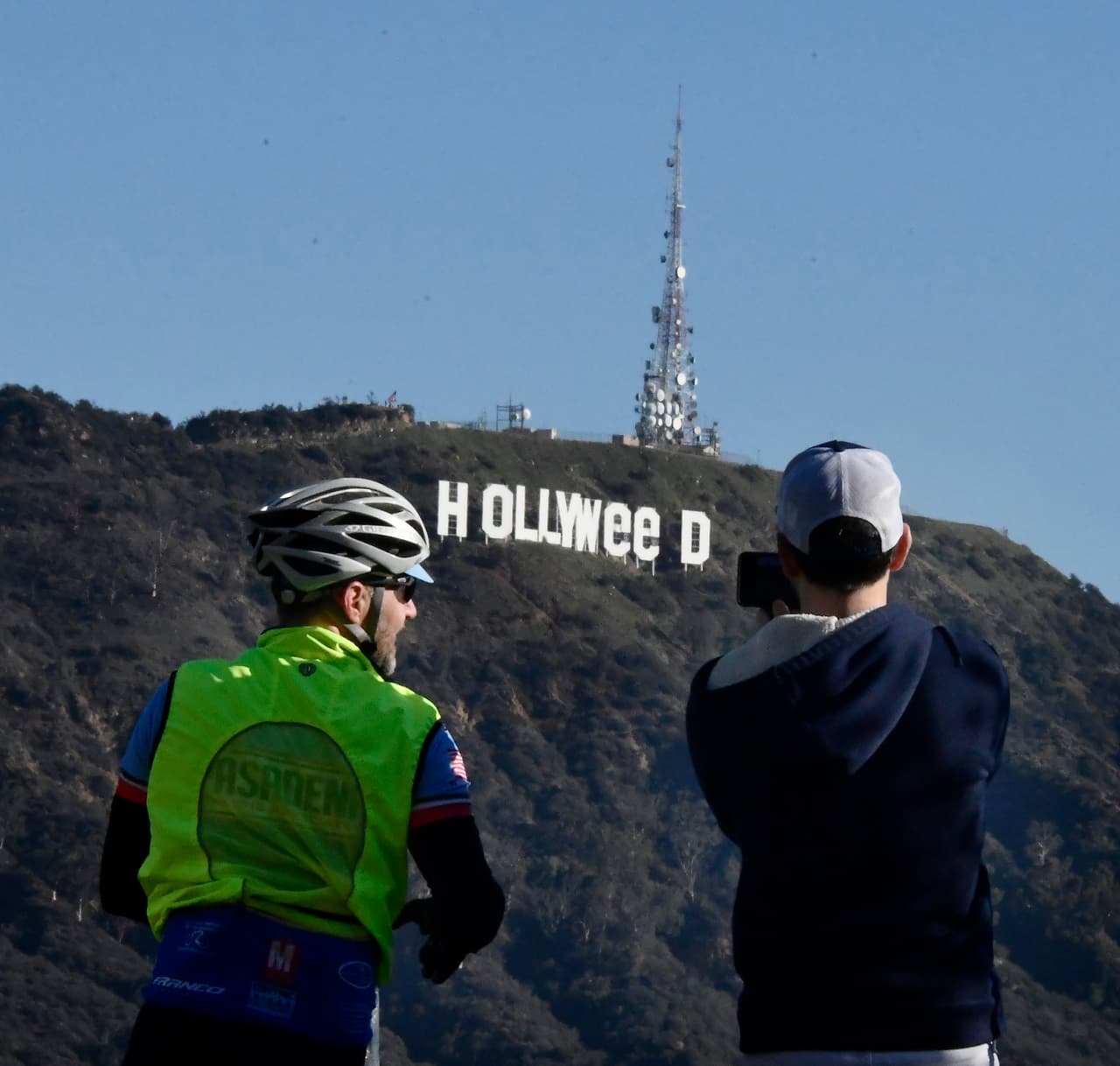 The famous Hollywood sign reads "Hollyweed" after it was vandalized, January 1, 2017. Police said unidentified thrill-seekers had climbed up and arranged tarps over the two letter "O's" to make them look like "E's," CBS affiliate KCAL reported. Each letter is 45 feet (13.7 meters) high, so the feat would have required not just bravado but considerable athleticism. / AFP / Gene BLEVINS (Photo credit should read GENE BLEVINS/AFP/Getty Images)