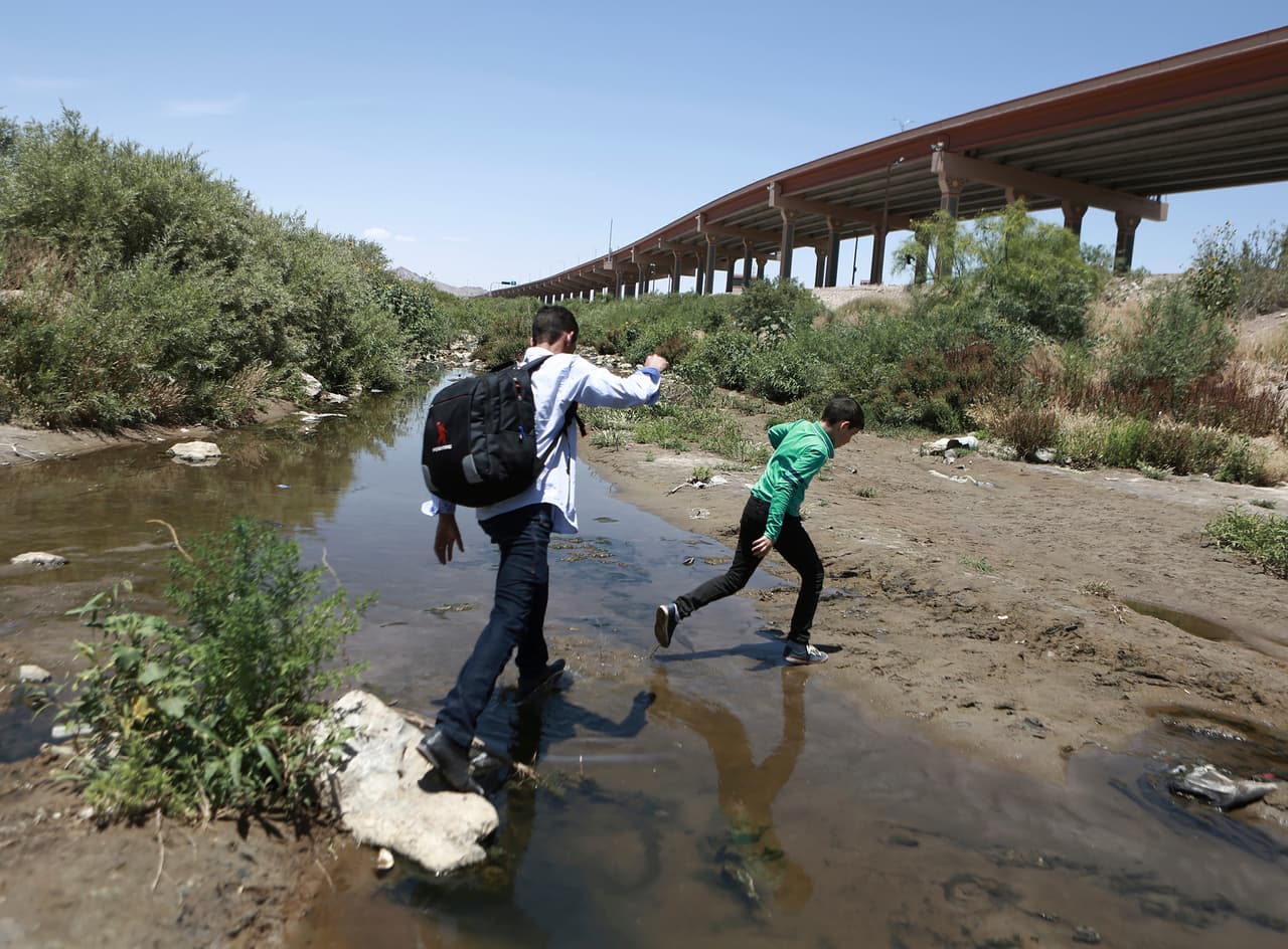 En esta foto de archivo del 7 de junio de 2019, un grupo de personas cruzan el Río Grande hacia los Estados Unidos para entregarse a las autoridades y pedir asilo, en El Paso, Texas.