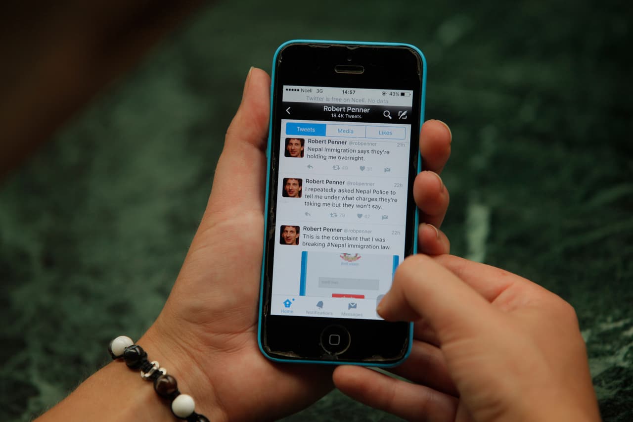 Twitter page of Canadian man, Robert Penner is seen on the screen of a mobile phone in Kathmandu, Nepal, Tuesday, May 3, 2016. Nepalese officials say they have ordered Penner to leave the country within two days for posting messages on social media that could disturb social harmony. (AP Photo/Niranjan Shrestha)