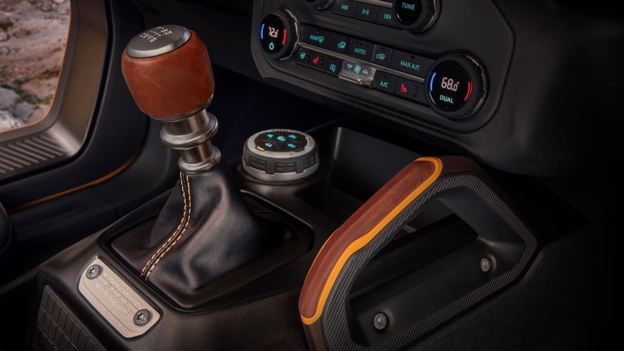 Customization details include an available leather-wrapped shift lever for the class-exclusive 7-speed manual transmission, as well as grab handles in this prototype version of the 2021 Bronco (not representative of production model). (Static display on private property with aftermarket accessories not available for sale.)