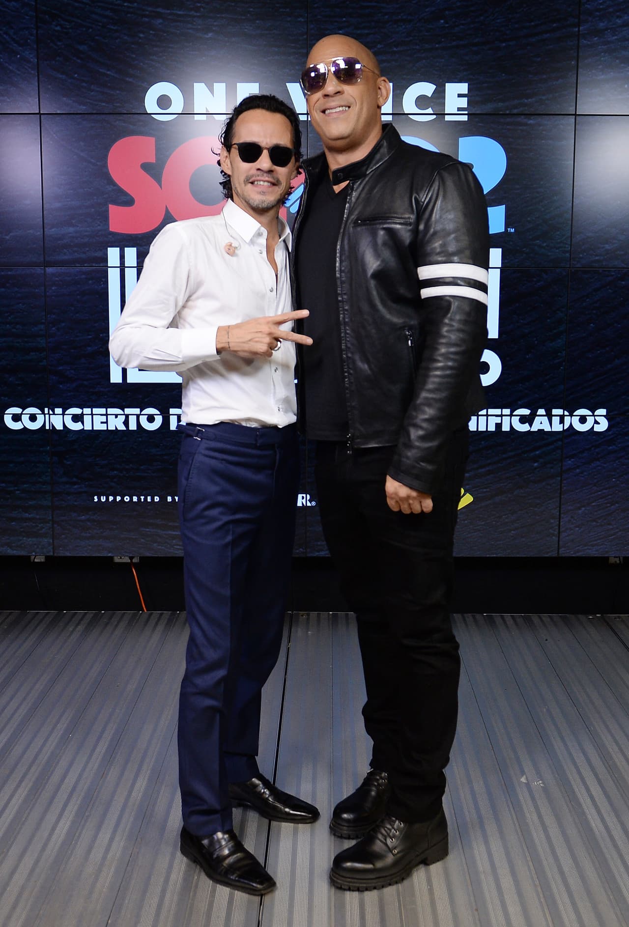 MIAMI, FL - OCTOBER 14: In this handout photo provided by One Voice: Somos Live!, Marc Anthony and Vin Diesel pose in the pressroom at One Voice: Somos Live! A Concert For Disaster Relief at Marlins Park on October 14, 2017 in Miami, Florida. (Photo by Jason Koerner/One Voice: Somos Live!/Getty Images)