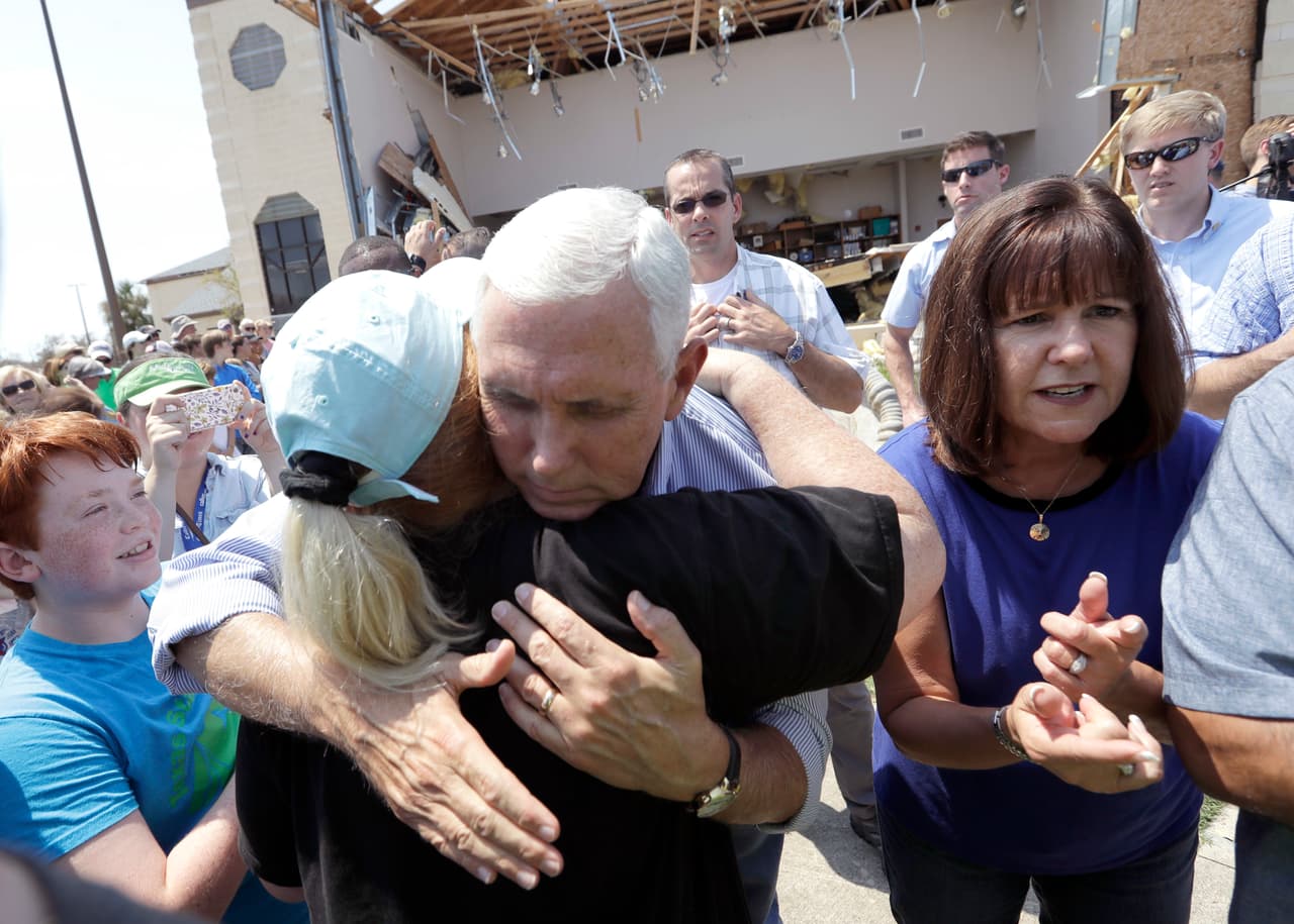 Vice President Mike Pence, center, with his wife Karen, right, shares a hug as he tries to encourage residents effected by Hurricane Harvey during a visit, Thursday, Aug. 31, 2017, in Rockport, Texas. (AP Photo/Eric Gay)