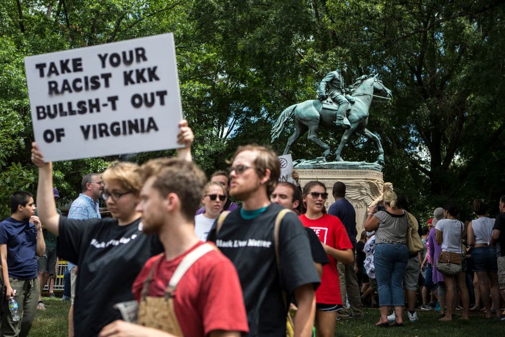 Screaming "racists, go home", the crowd drowned out the Klan's songs. Some brief skirmishes erupted despite police lines. Counter-protesters tried to prevent paramilitaries from entering and leaving the park, videos show.
