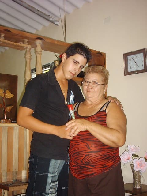 José Delfin with his adoring grandmother Olga. She was passionate about baseball and prcaticed with him. After José left Cuba in 2008 she stayed behind. In 2013 she was granted a visa to visit Miami and from then on never missed a game he pitched during his brief career. Courtesy of the Fernández family/Univision.