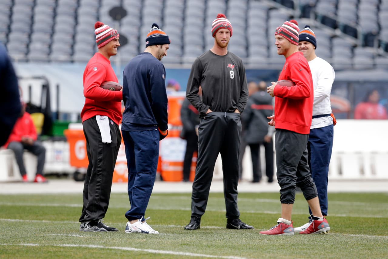 Tampa Bay Buccaneers and Chicago Bears quarterbacks from left, the Buccaneers' Mike Kafka, Bears' Jay Cutler, the Buccaneers' Mike Glennon, the Buccaneers' Josh McCown, and the Bears' Jimmy Clausen gather before an NFL football game Sunday, Nov. 23, 2014, in Chicago. (AP Photo/Nam Y. Huh)