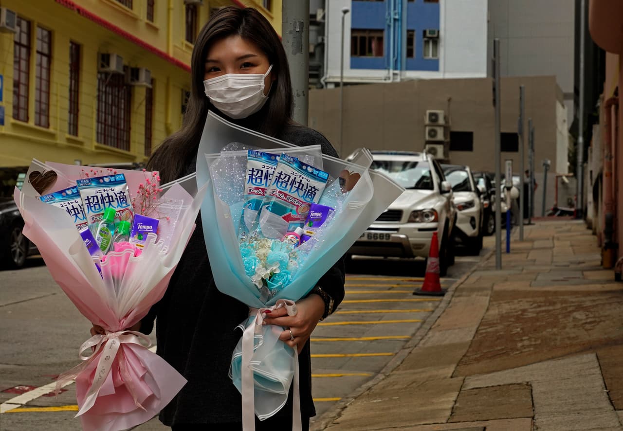 Iris Leung, dueña de una floristería, lleva su mascarilla mientras entrega flores para algunos clinetes este Día de San Valentín.