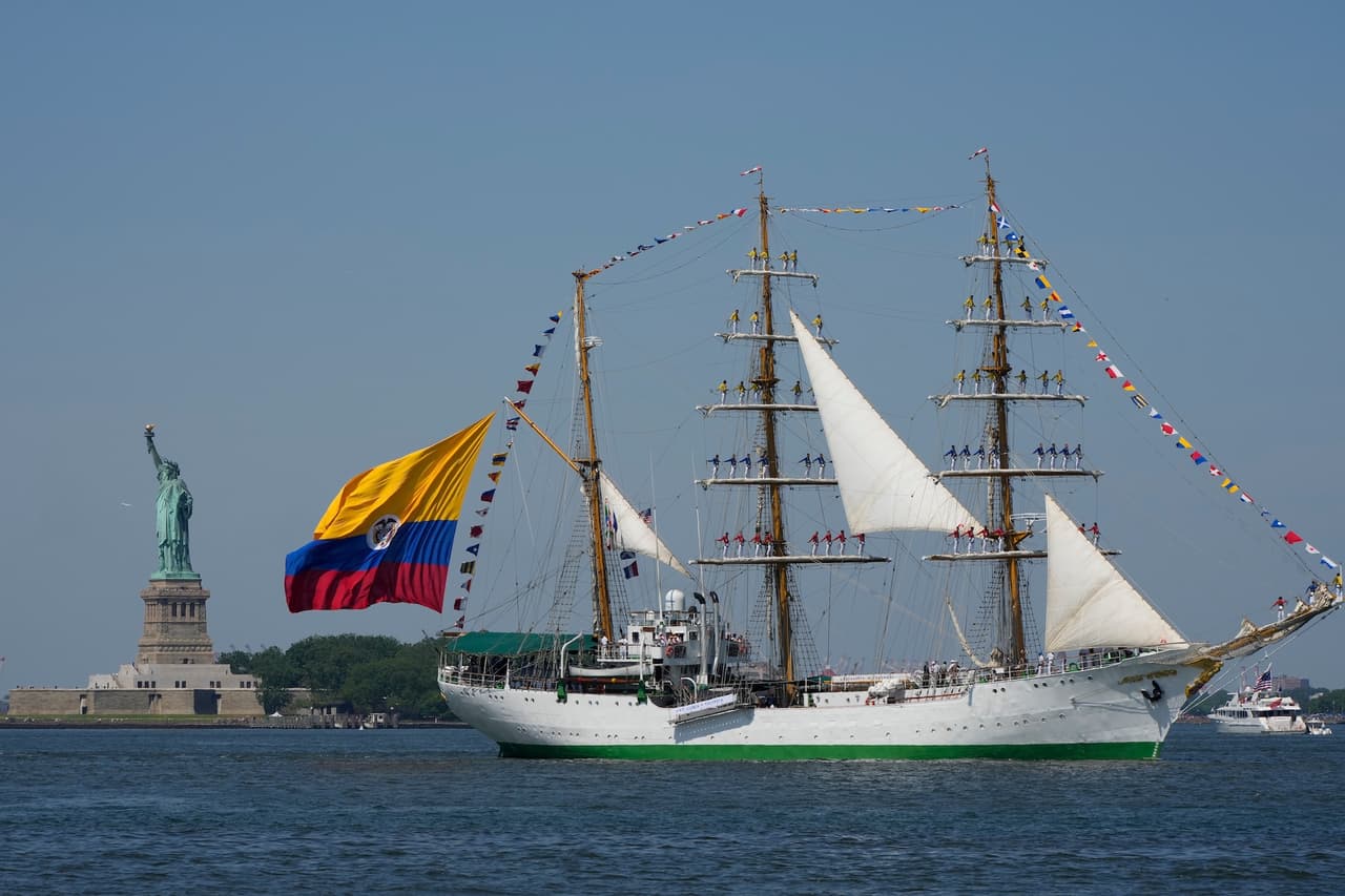 El velero colombiano Arc Gloria navega frente a la Estatua de la Libertad durante el Desfile Internacional de Barcos, parte de Sail4th 250.