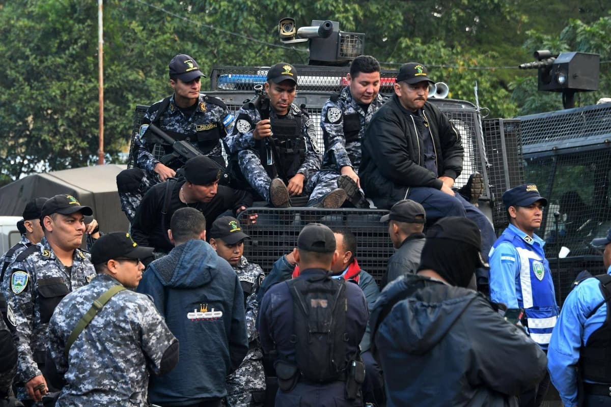 Members of Honduras National Police and police officers belonging to COBRA Special Riot Command stand outside the COBRA headquarters as they refuse to crack down on demonstrators in Tegucigalpa, on Dec. 5, 2017.
