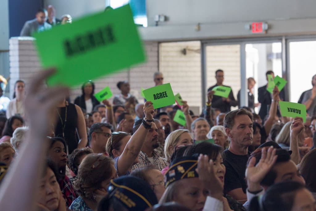 LOS ANGELES, CA - APRIL 21: People hold signs to express agreement as U.S. Senator Kamala D. Harris holds a town hall at Holman United Methodist Church on April 21, 2017 in Los Angeles, California. A diverse audience of community members responded in general agreement with statements and answers expressed by Harris. (Photo by David McNew/Getty Images)