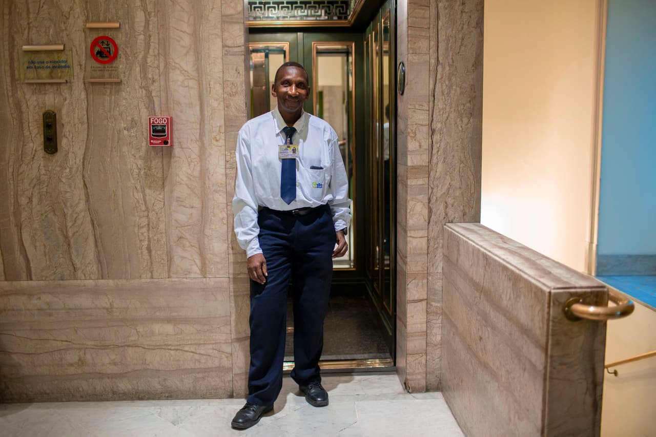 <b>Ascensorista, Brasil.</b> Dilson Lopes Santana, de 60 años, conduce el elevador del Centro Cultural del Banco de Brasil, en el centro de Río de Janeiro. Dilson, quien vive en la favela Cantagalo, ha tenido este trabajo durante veinticinco años. Le contó a la agencia AFP que cada vez que puede ofrece a los visitantes sugerencias de las salas de exposiciones, los teatros y la biblioteca del centro cultural, conectados por los ascensores del inmenso edificio.