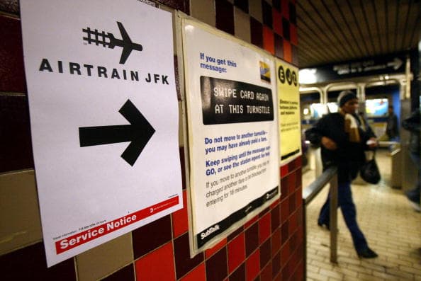 NEW YORK- DECEMBER 17: People walk in a subway station that connects to a new terminal for AirTrain December 17, 2003 at in New York City. AirTrain is a light rail service that connects John F. Kennedy Airport to the MTA Long Island Rail Road (LIRR) trains, MTA New York City Transit subways and local buses at the Howard Beach and Jamaica train stations.Passengers on AirTrain JFK can use the system, free of charge, to connect between the airline terminals, rental car facilities, hotel shuttles, and on-airport parking. (Photo by Spencer Platt/Getty Images)