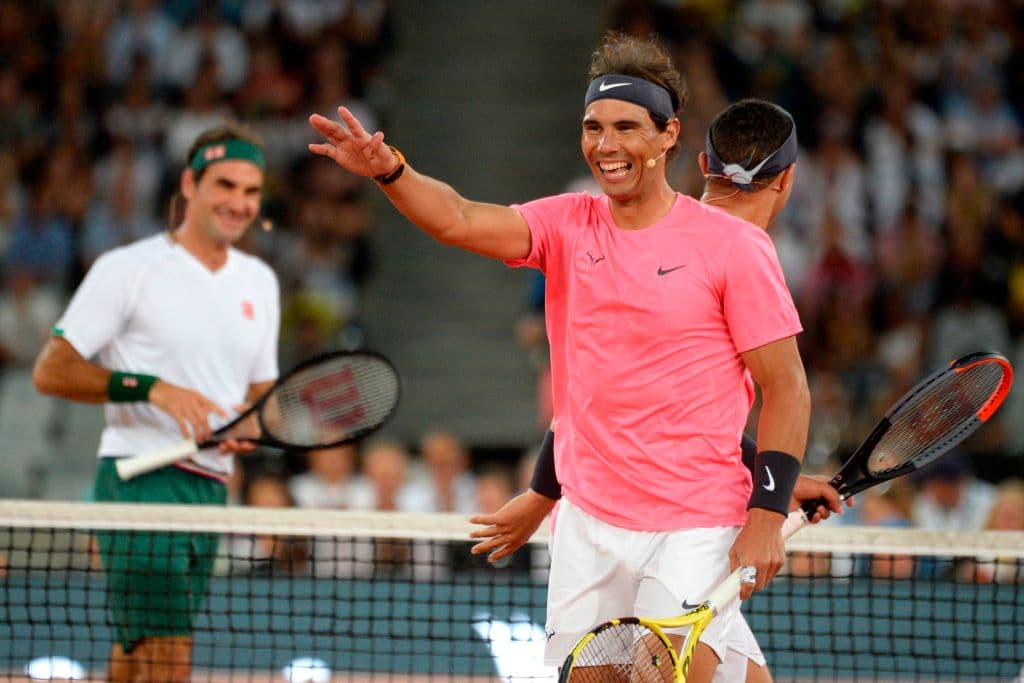 Spain's Rafael Nadal (C) reacts after a point against Switzerland's Roger Federer (L) and American philanthropist Bill Gates during their double's tennis match at The Match in Africa at the Cape Town Stadium, in Cape Town on February 7, 2020. (Photo by RODGER BOSCH / AFP) (Photo by RODGER BOSCH/AFP via Getty Images)