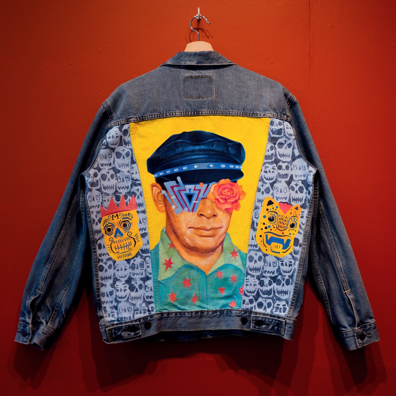 No Surface is Safe (R.I.P. Michael Roman): La obra, que Rodríguez pintó sobre la superficie de una chaqueta, muestra el retrato de un artista de la Misión llamado Michael Roman, que lo inspiró mucho. “Muchos artistas chicanos representan el pasado en su trabajo, pero Roman trató de evolucionar el arte chicano e incorporar nuevos elementos, siempre con un ojo al futuro. Vio su proceso como un pinball, yendo de un estilo o punto de referencia a otro”.