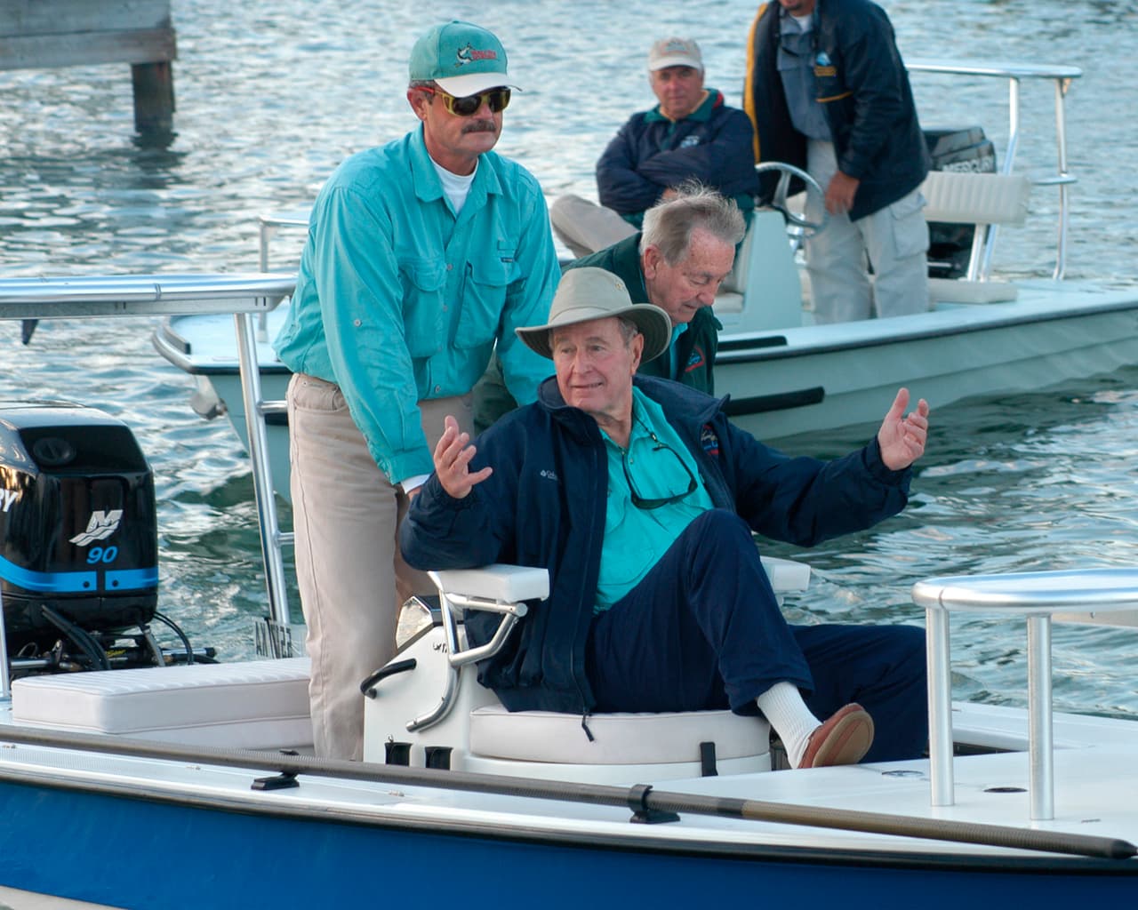 El presidente George H.W Bush hace un gesto hacia sus compañeros pescadores cuando sale del muelle el 20 de noviembre de 2002, para el primer día de pesca en el torneo ‘Bonefish George Bush’ en los Cayos de Florida.