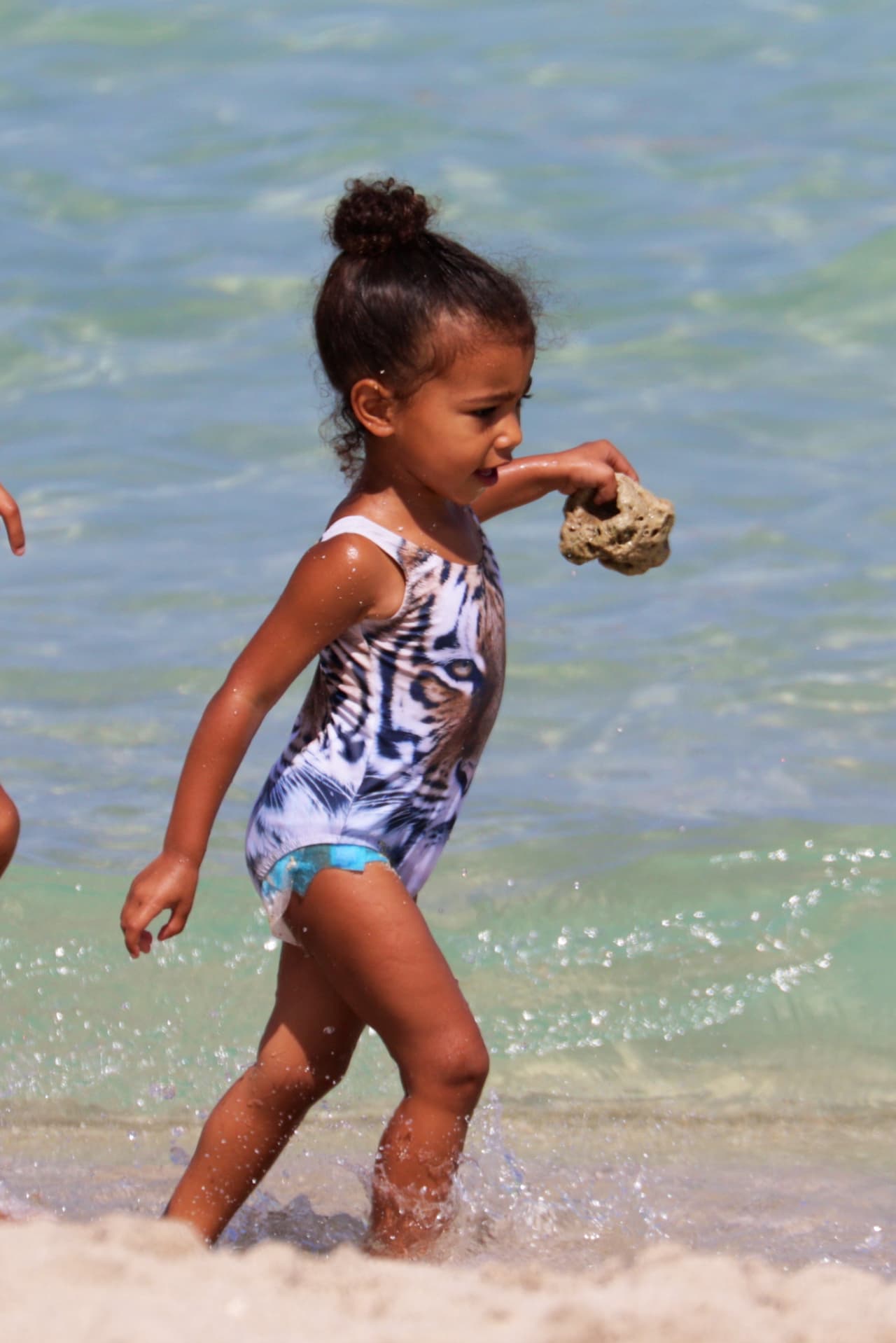 Lucía de lo más feliz corriendo en las olas.
