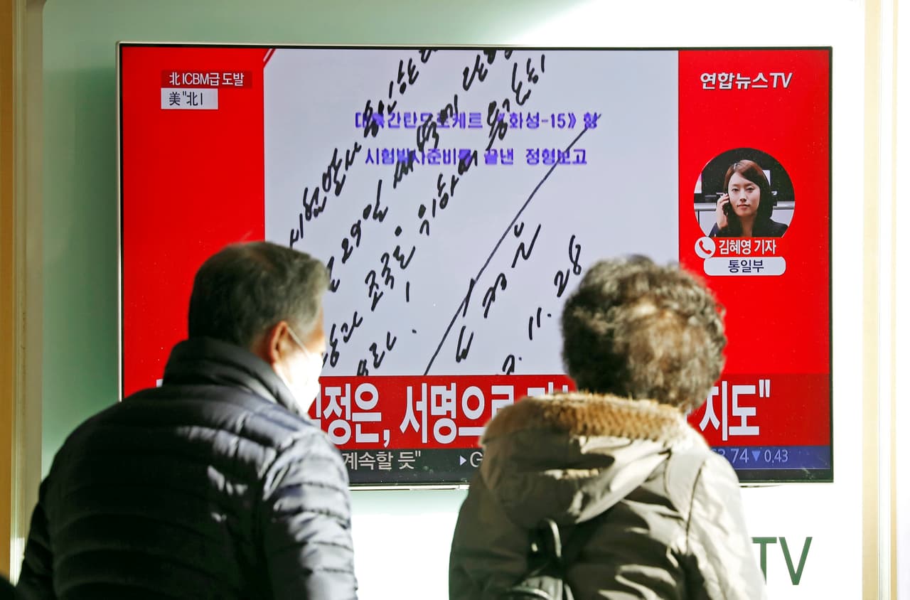 People watch a TV broadcasting a news report on North Korea firing what appeared to be an intercontinental ballistic missile (ICBM) that landed close to Japan, in Seoul, South Korea, November 29, 2017. In this handwritten order visible on a screen, dated November 28 by Kim Jong Un, he says: "I order a test launch. Carry out on Nov 29 at dawn. Fire it bravely for the Party and the motherland!" REUTERS/Kim Hong-Ji