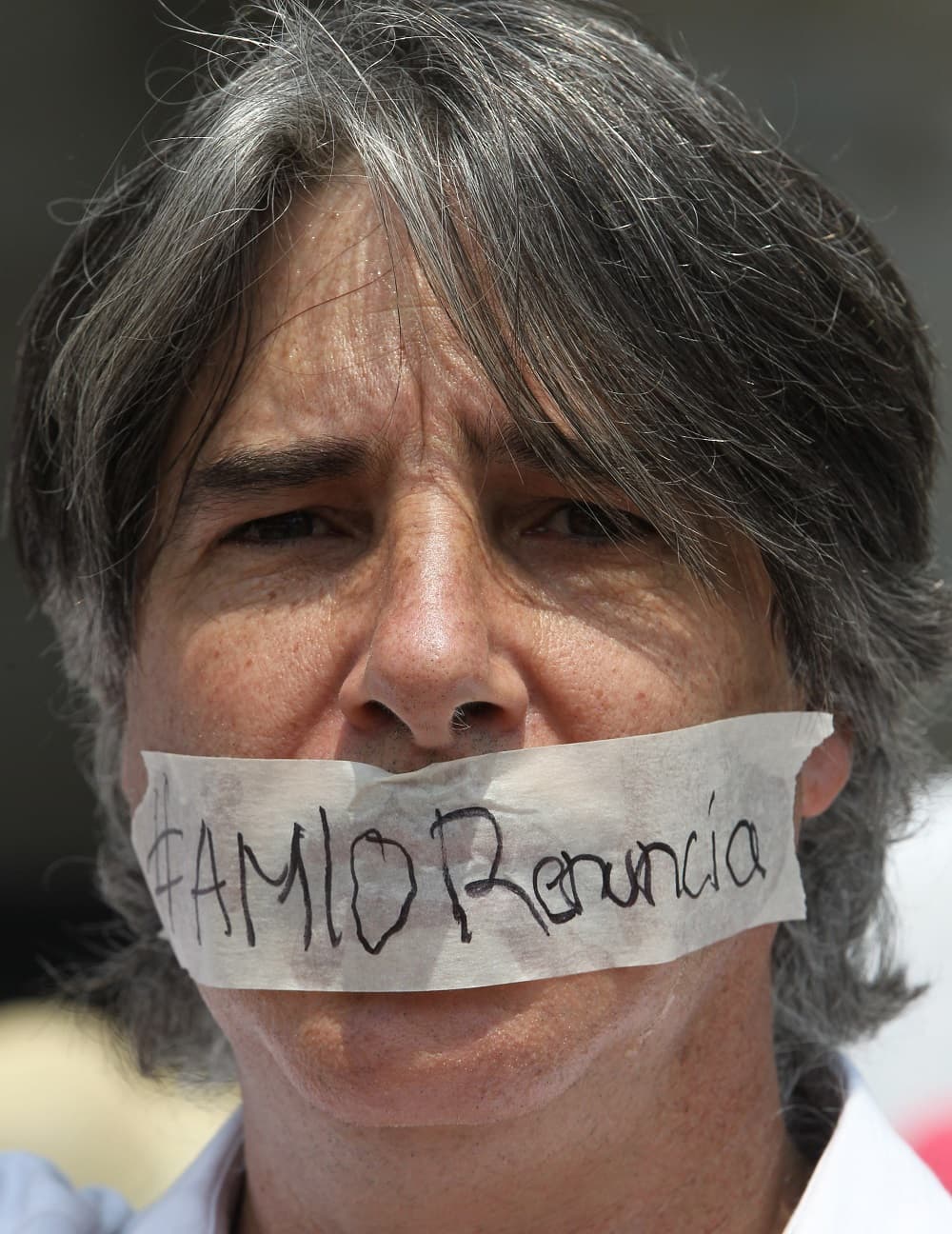 Algunos de los manifestantes se taparon la boca con cinta adesiva donde marcaron algunos de los lemas.