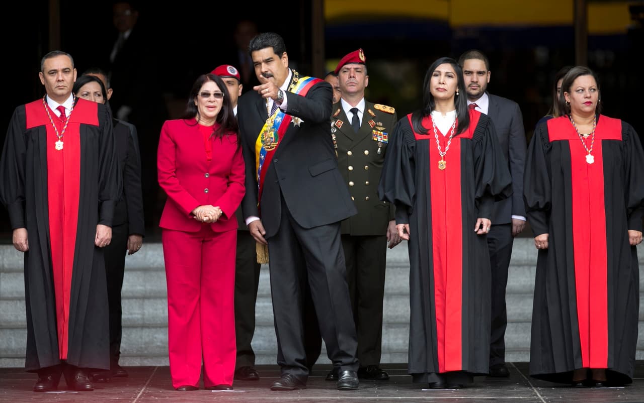 Venezuela’s President Nicolas Maduro speaks with first lady Cilia Flores as they arrive to the Supreme Court, before delivering his state of the union address, in Caracas, Venezuela.