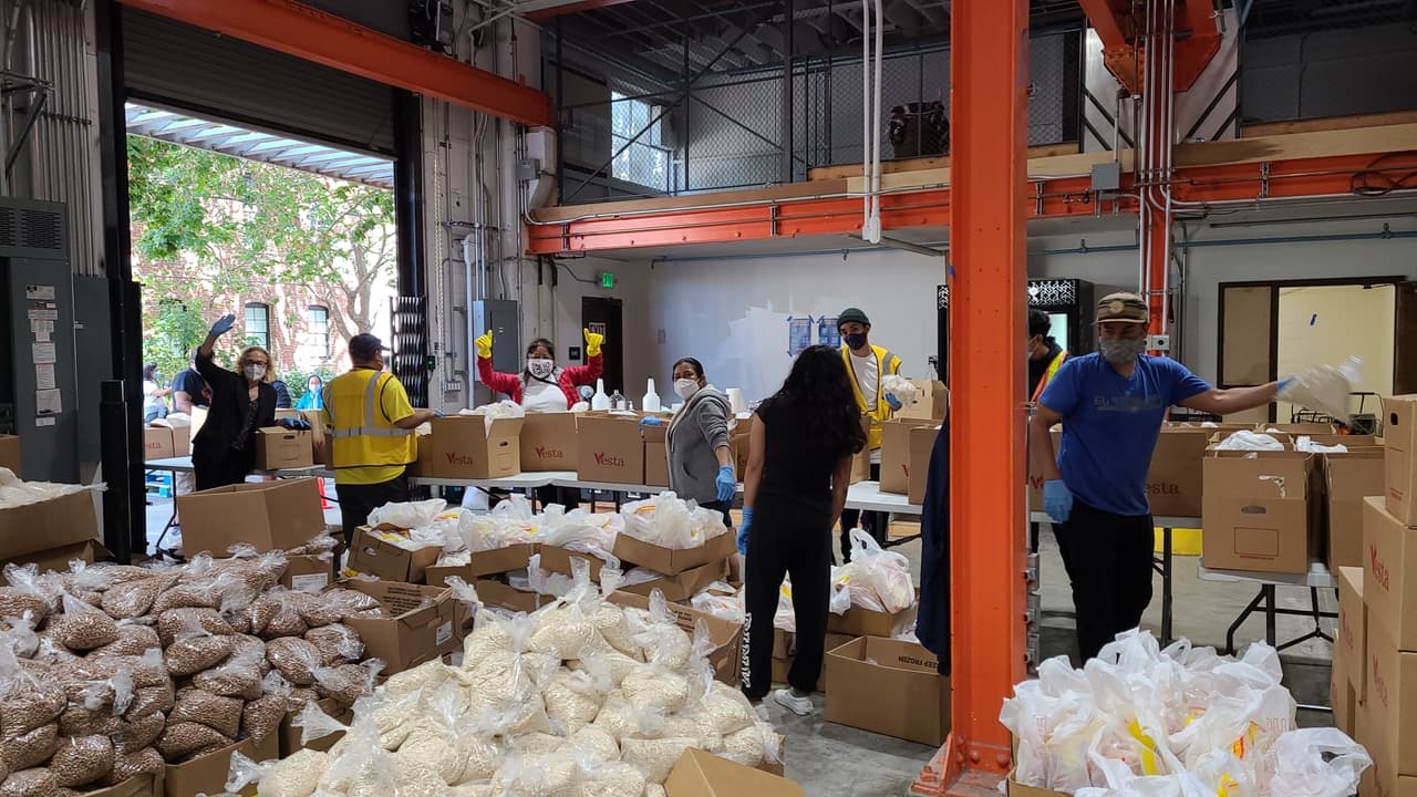 Algunos de los voluntarios que llenan y mueven las cajas para luego ser distribuidas entre las familias necesitadas.