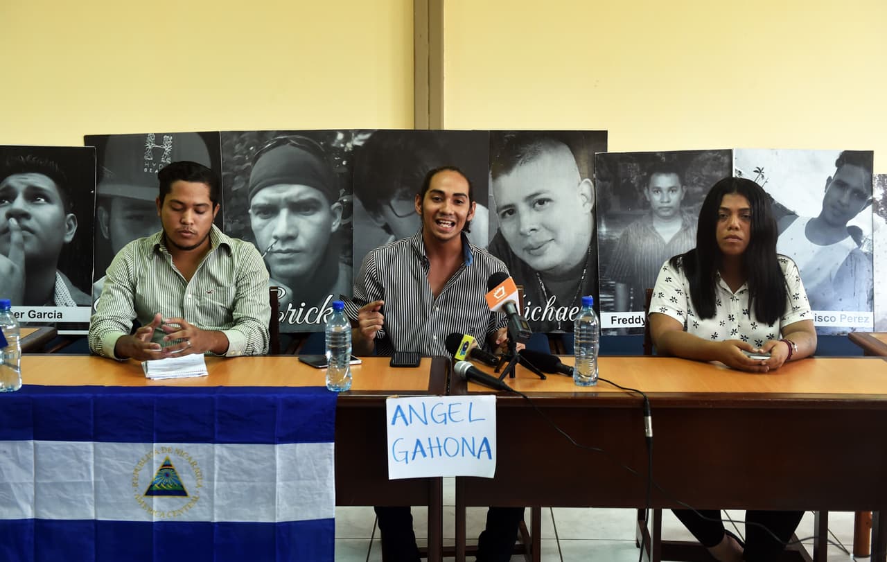 Students Jeancarlo Lopez (C), Freddy Martinez (L) and Valeska Valle offer a press conference at Nicaragua's Polytechnic University in Managua on April 26, 2018, as Nicaragua hangs on to the prospect of talks to calm anti-government sentiment behind a week of protests in which at least 34 people died. - A week of brutally repressed anti-government protests has killed at least 34 people. The protests were triggered by pension reforms that President Daniel Ortega ended up withdrawing amid mounting condemnation of the harsh police tactics against the demonstrators. (Photo by Rodrigo ARANGUA / AFP) (Photo credit should read RODRIGO ARANGUA/AFP/Getty Images)