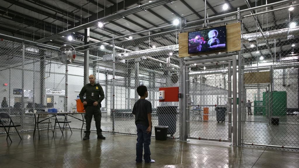 A child separated from his parents watches a movie in a detention center in Texas.