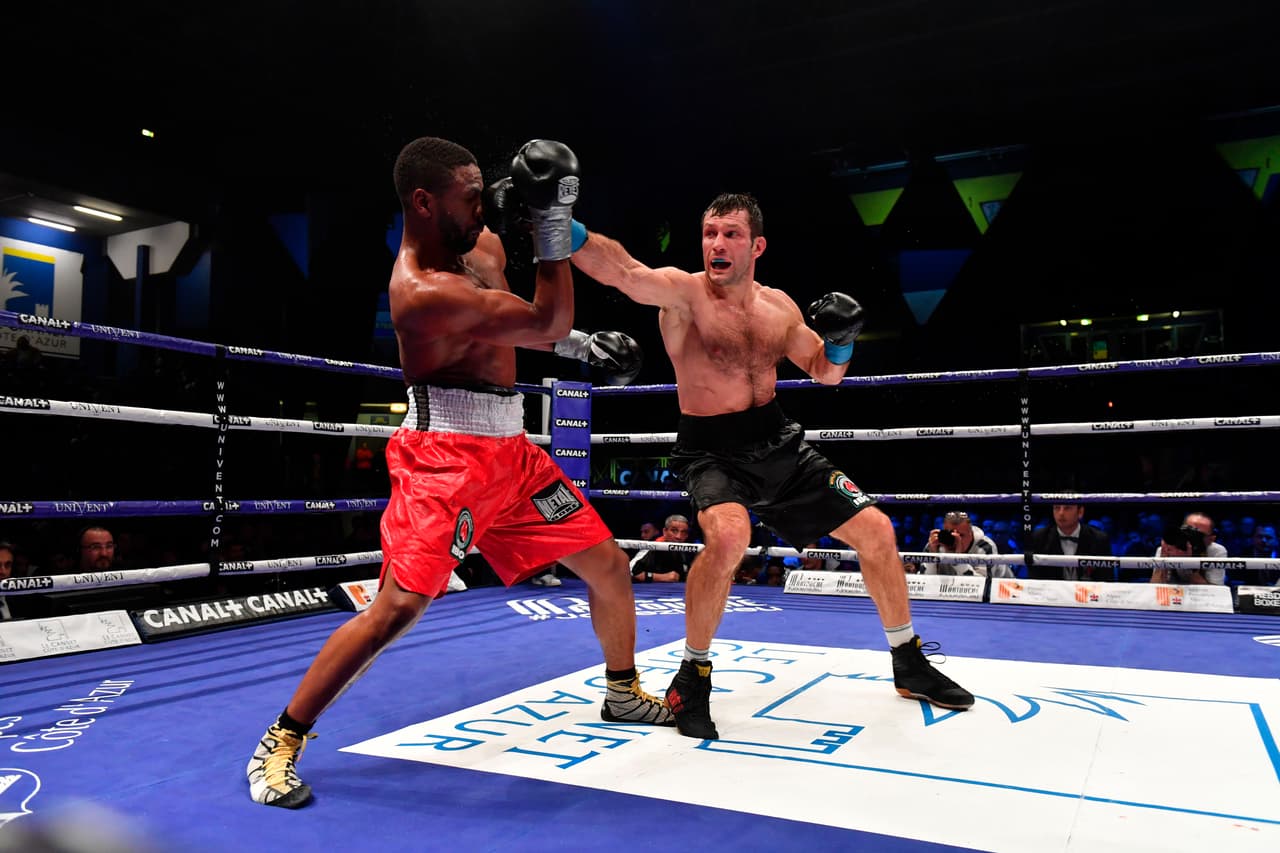 France's Doudou Ngumbu (L) fights with Russia's Igor Mikhalkin(R) during the IBO World Light Heavyweight fight in Le Cannet, southeastern France on December 2, 2017. / AFP PHOTO / YANN COATSALIOU (Photo credit should read YANN COATSALIOU/AFP/Getty Images)