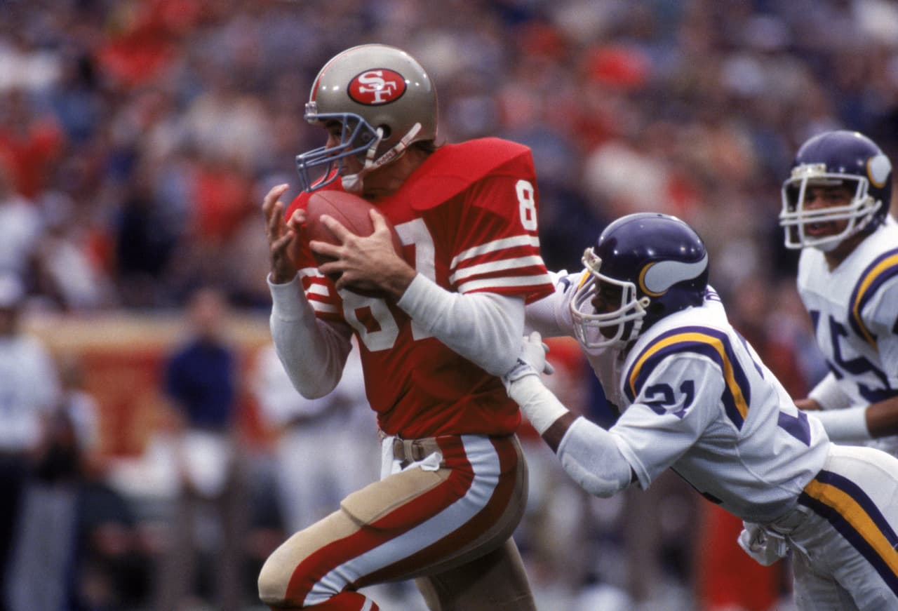 SAN FRANCISCO - DECEMBER 8: Wide receiver Dwight Clark #87 of the San Francisco 49ers catches a pass against defensive back Rufus Bess #21 of the Minnesota Vikings during a game at Candlestick Park on December 8, 1984 in San Francisco, California. The 49ers won 51-7. (Photo by George Rose/Getty Images)