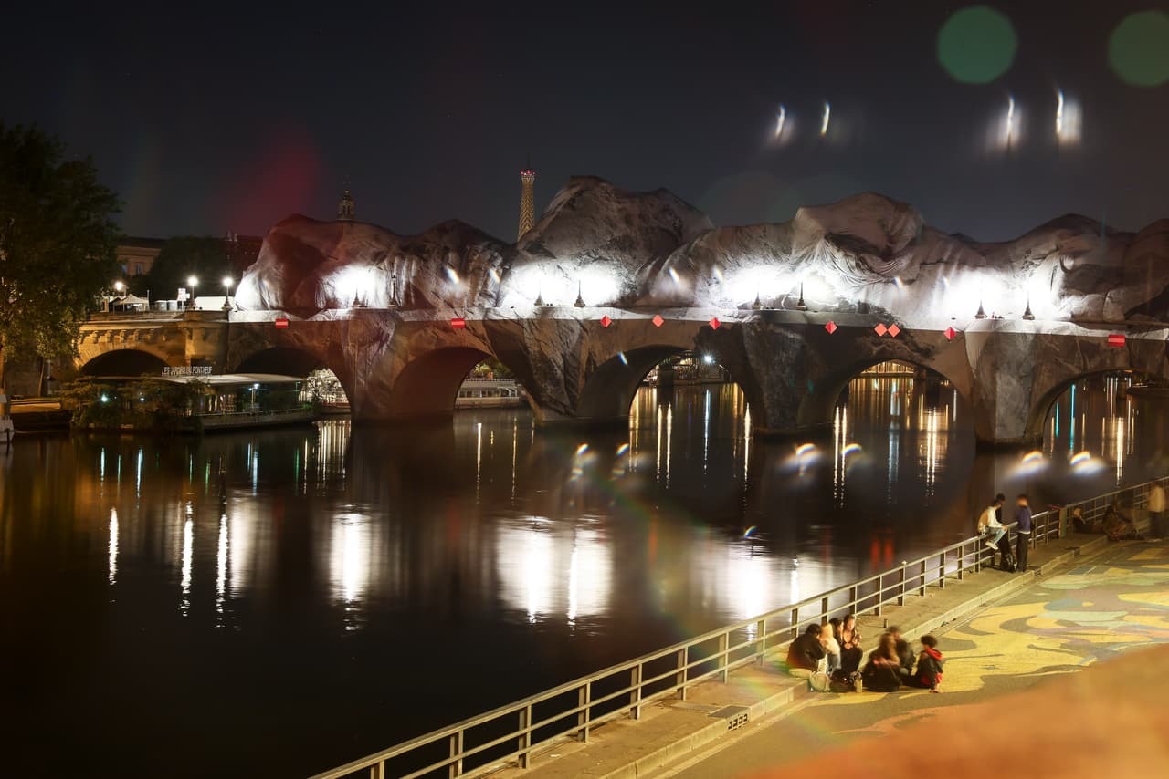 Inflado de la obra de arte "La cueva del Pont Neuf" del artista callejero francés JR en el puente Pont Neuf, con la Torre Eiffel de fondo, el miércoles 20 de mayo de 2026, en París, antes de su inauguración gratuita al público del 6 al 28 de junio. (Foto AP/Thomas Padilla)