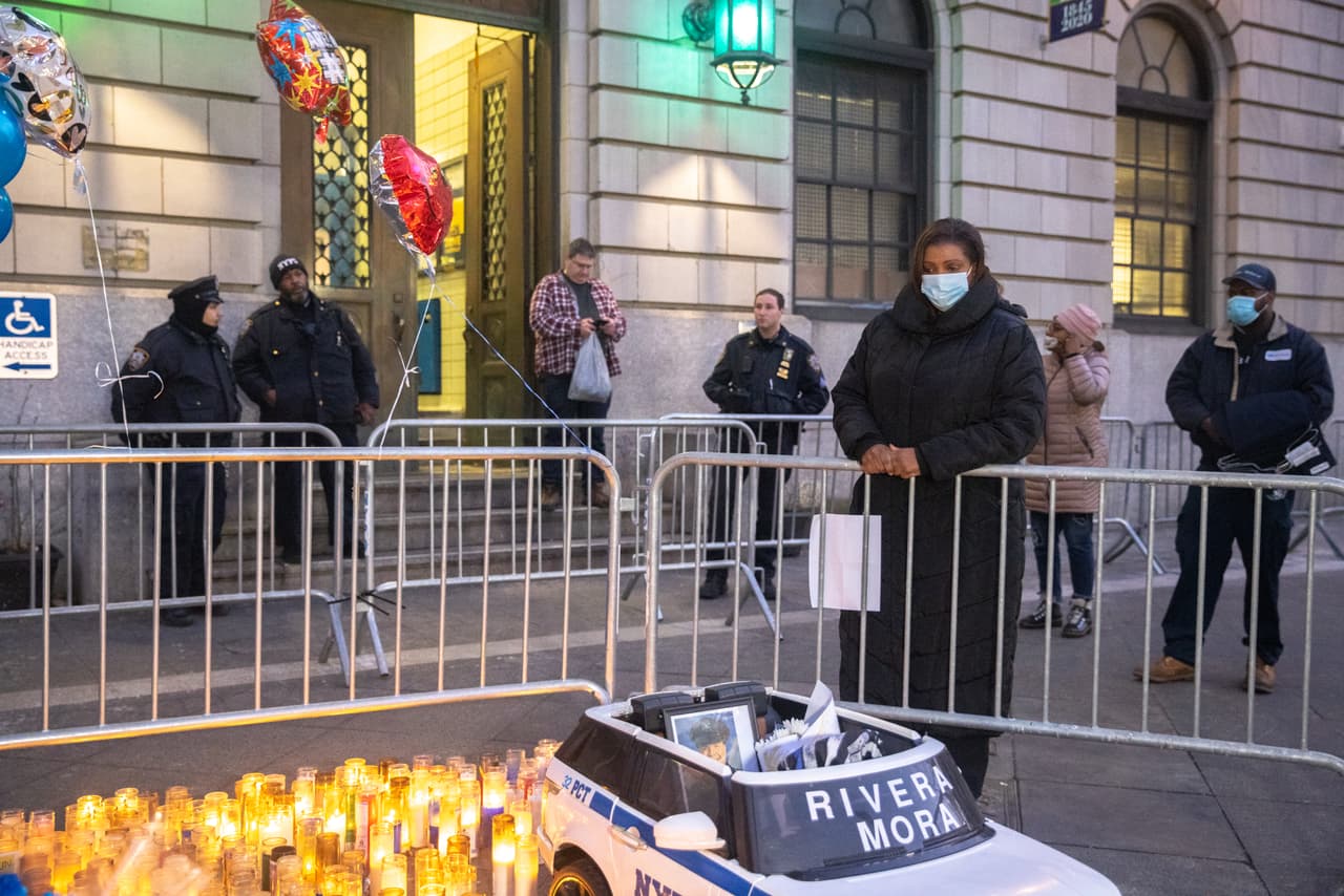 A las afueras del precinto donde Rivera y Mora trabajaban, no faltan las veladoras y flores.