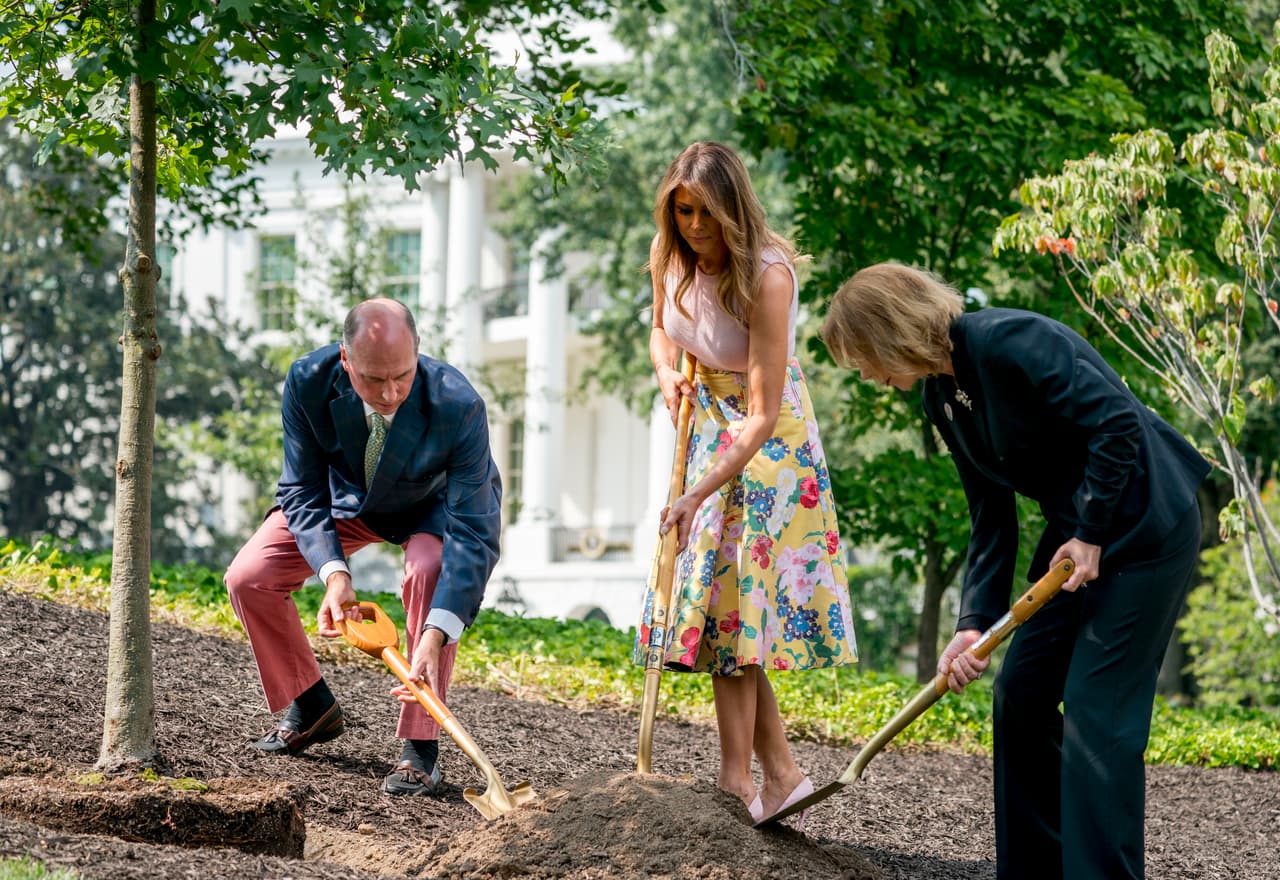 From left, President James Monroe's fifth generation grandson Richard Emory Gatchell, Jr., first lady Melania Trump, and President Dwight Eisenhower's granddaughter Mary Jean Eisenhower, participate in a presidential tree planting ceremony on the South Lawn of the White House, Monday, Aug. 27, 2018, in Washington. The sapling was grown from the Eisenhower Oak and replaces a tree which blew down during a windstorm earlier this year. Additionally, this year marks the 200th anniversary of President Monroe's family moving back into the White House after the British set fire to it during the War of 1812. (AP Photo/Andrew Harnik)