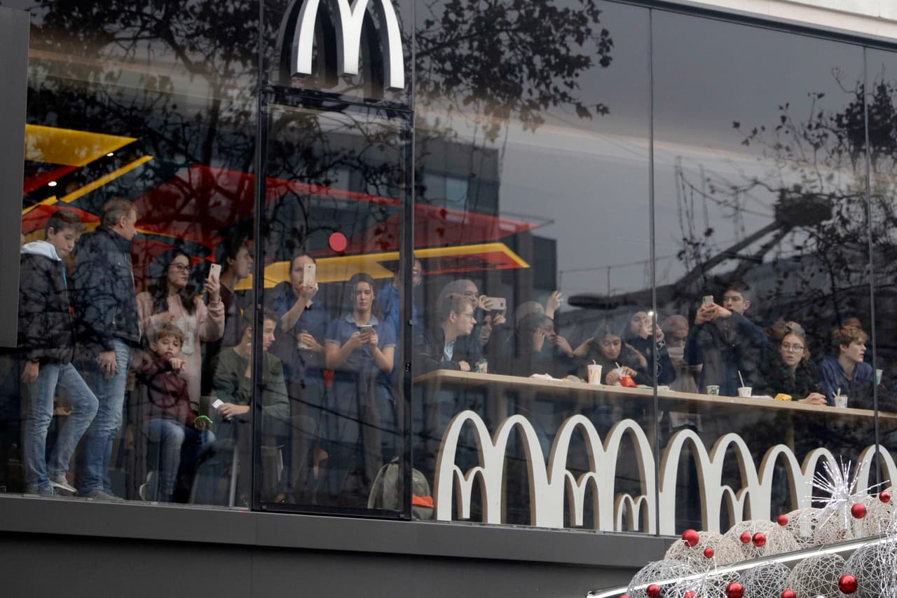 Clientes de un restaurante McDonald's se quedan atrapados en el local en la avenida Champs-Elysees. AP/Kamil Zihnioglu.