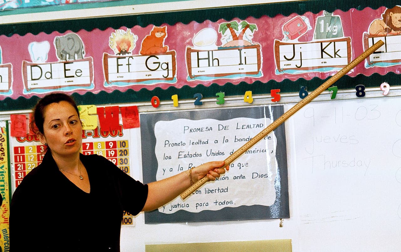 TYLER,TX - SEPTEMBER 11: Lourdes Carmona, a Spanish speaking first grade teacher, instructs a class on the Spanish pronunciations of the alphabet at Birdwell Elementary School September 11, 2003 in Tyler, Texas. Carmona, a native of Spain, was recruited 5 years ago to teach Spanish speaking youngsters reading, writing, and arithmetic in their native language, as there was and continues to be a shortage of bilingual teachers in Texas. Carmona and her husband, also a native of Spain, are both employed by the Tyler Independent School District and permanently live in the east Texas city. (Photo by Mario Villafuerte/Getty Images)