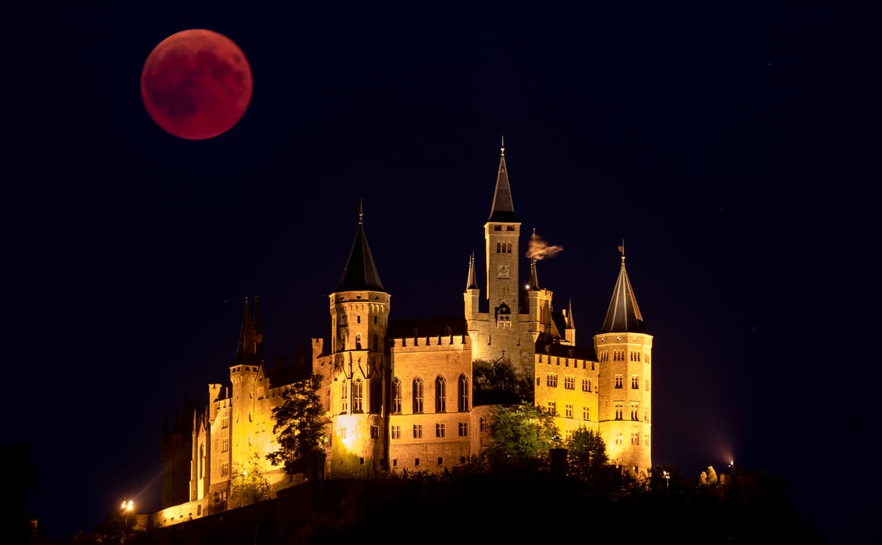 La 'Luna de sangre' se alza detrás del castillo de Hohenzollern, la sede ancestral de la casa real prusiana, en Hechingen, Alemania. 
<br>