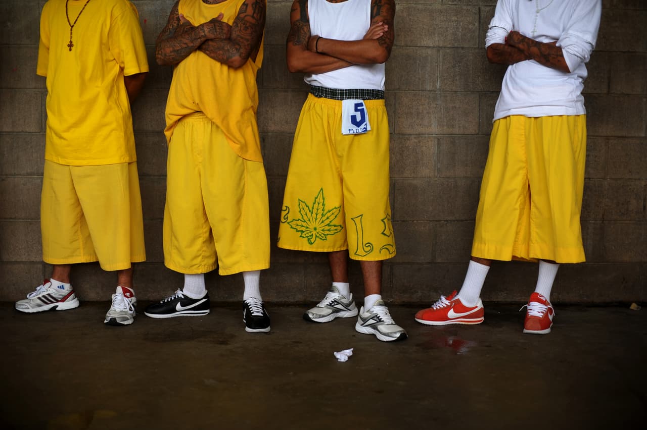 Members of the Mara 18 gang, attend a mass at the Izalco Penitenciary in the city of Izalco, 70 Km west of San Salvador on April 13, 2012. Catholic priest Fabio Colindres, negociator of the Catholic church, celebrated a mass to thank for the truce between the gangs Mara 18 and Mara Salvatrucha, to down murder rates in El Salvador. AFP PHOTO/Jose CABEZAS. / AFP PHOTO / Jose CABEZAS (Photo credit should read JOSE CABEZAS/AFP/Getty Images)