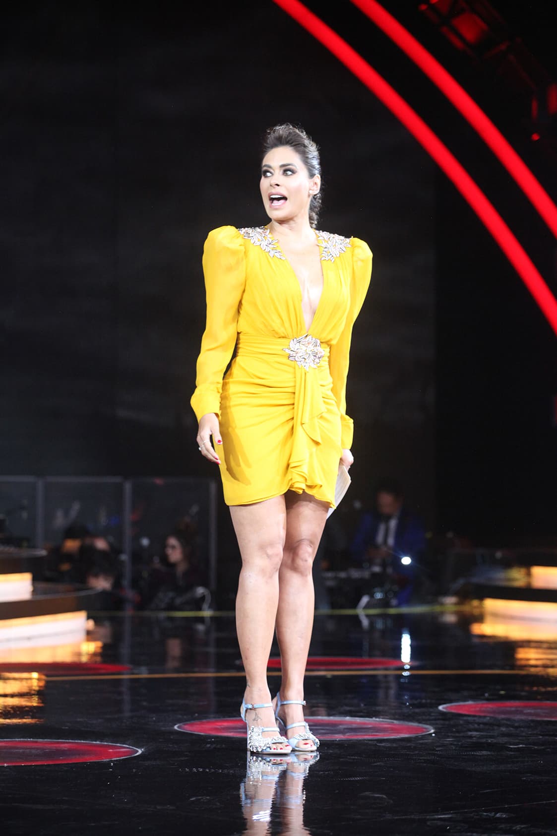 Ese domingo, Galilea sorprendió no sólo por su look, sino por lucir pupilentes color miel, que aclararon su mirada: "Los usamos nada más para que brille un poquito", explicó la presentadora. Para contrastar el color mostaza del vestido, usó un exclusivo calzado Paula Cademartori en satín azul cielo.