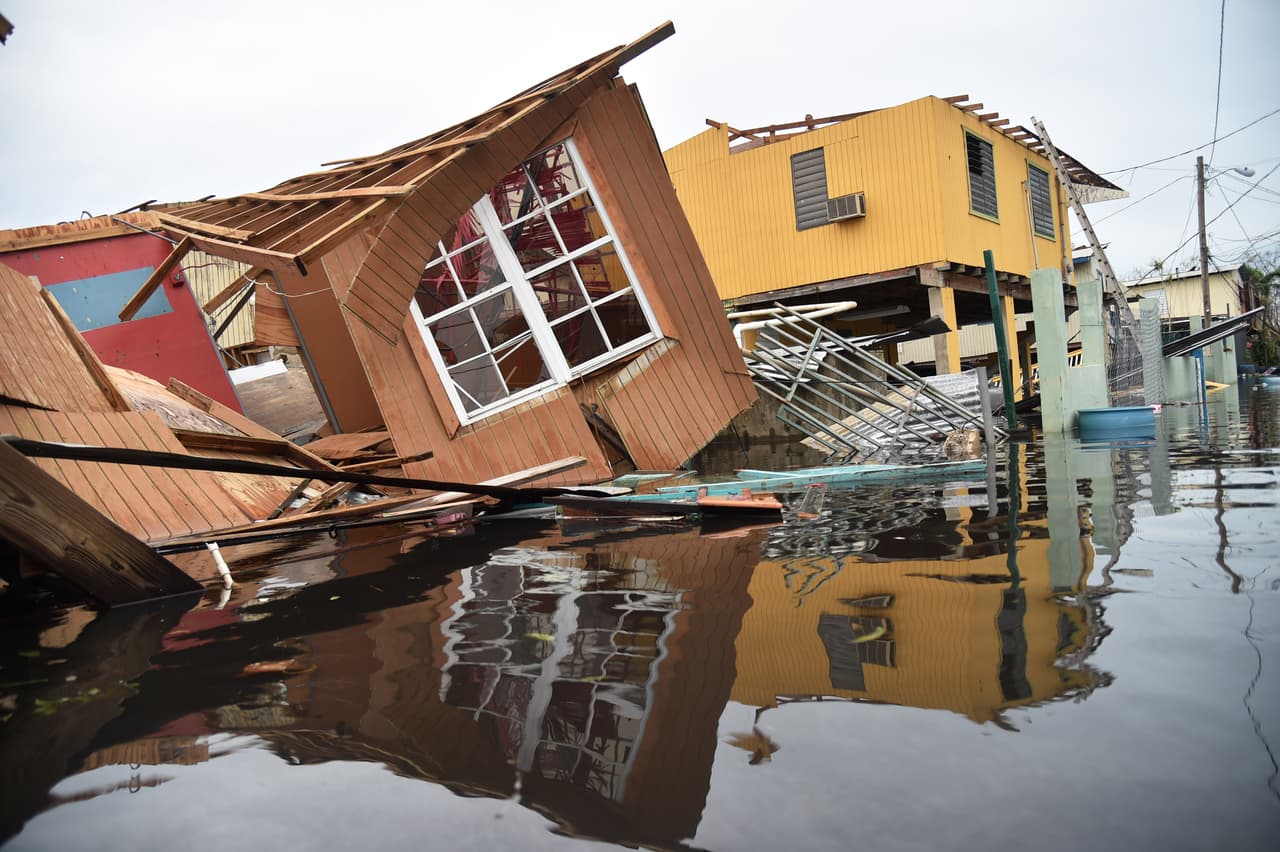 A destroyed house lays flooded in Catano town, in Juana Matos, Puerto Rico, on September 21, 2017. Puerto Rico braced for potentially calamitous flash flooding after being pummeled by Hurricane Maria which devastated the island and knocked out the entire electricity grid. The hurricane, which Puerto Rico Governor Ricardo Rossello called "the most devastating storm in a century," had battered the island of 3.4 million people after roaring ashore early Wednesday with deadly winds and heavy rain. / AFP PHOTO / HECTOR RETAMAL (Photo credit should read HECTOR RETAMAL/AFP/Getty Images)
