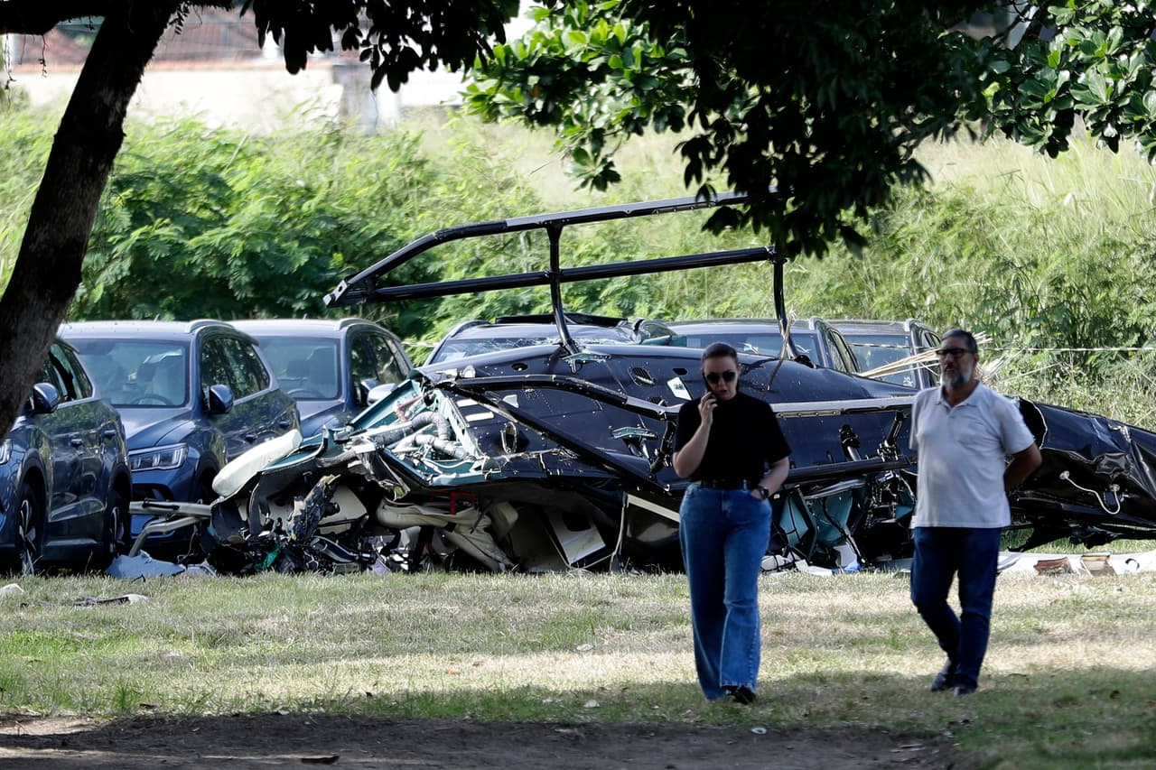 Helicopter wreckage lies at a car dealership parking lot where, according to police, two helicopters collided in midair and crashed in Rio de Janeiro, Brazil, Sunday, June 14, 2026. (AP Photo/Bruna Prado)