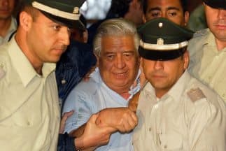 En una imagen de archivo, Manuel Contreras es custodiado por oficiales de policía.