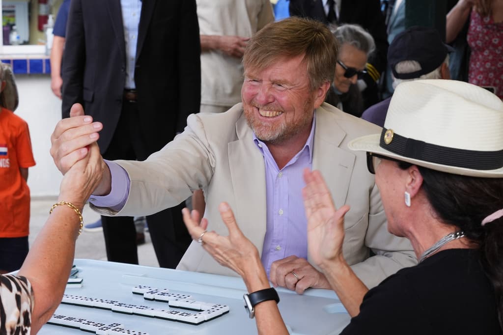 El rey Guillermo celebra una victoria en el juego de dominó.